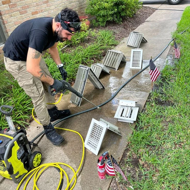 Removed vent covers being washed outdoors